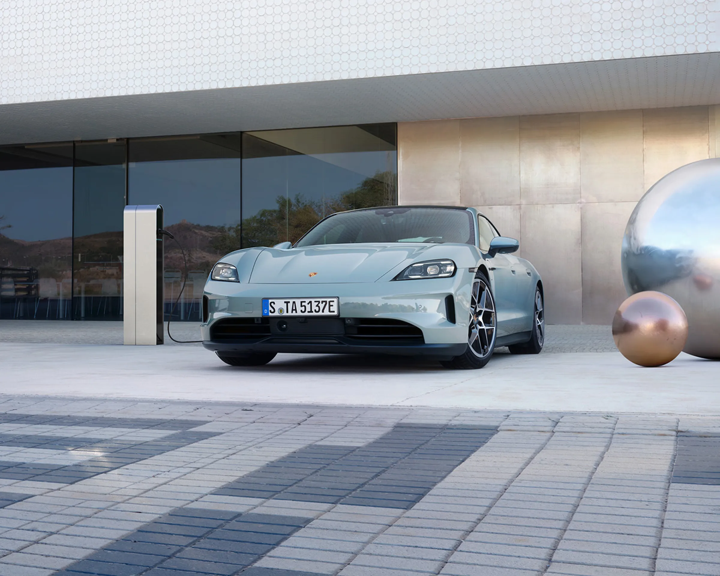 Une Porsche Taycan grise en charge